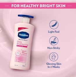 Vaseline body lotion bottle with product features on a pink background