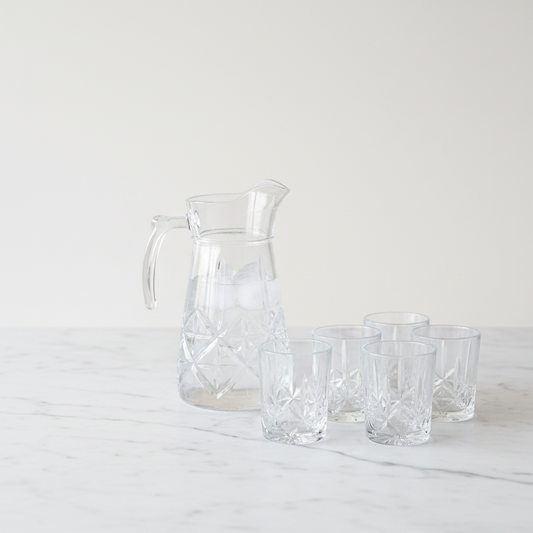 Delisoga crystal pitcher styled on white marble — editorial product photo