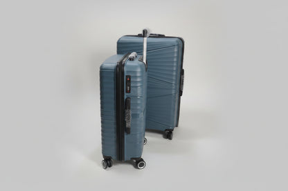 Two blue suitcases on wheels in a warehouse setting