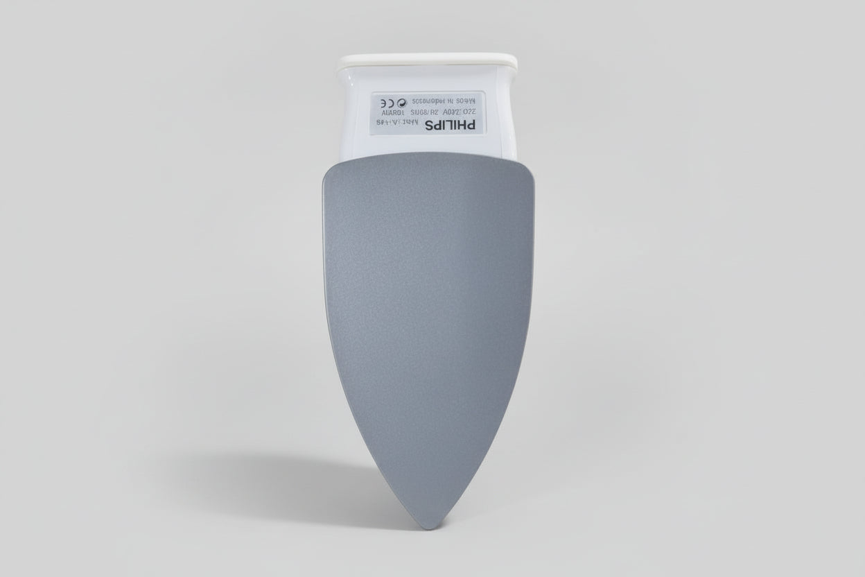 Gray Philips light bulb in a hand with a cluttered background