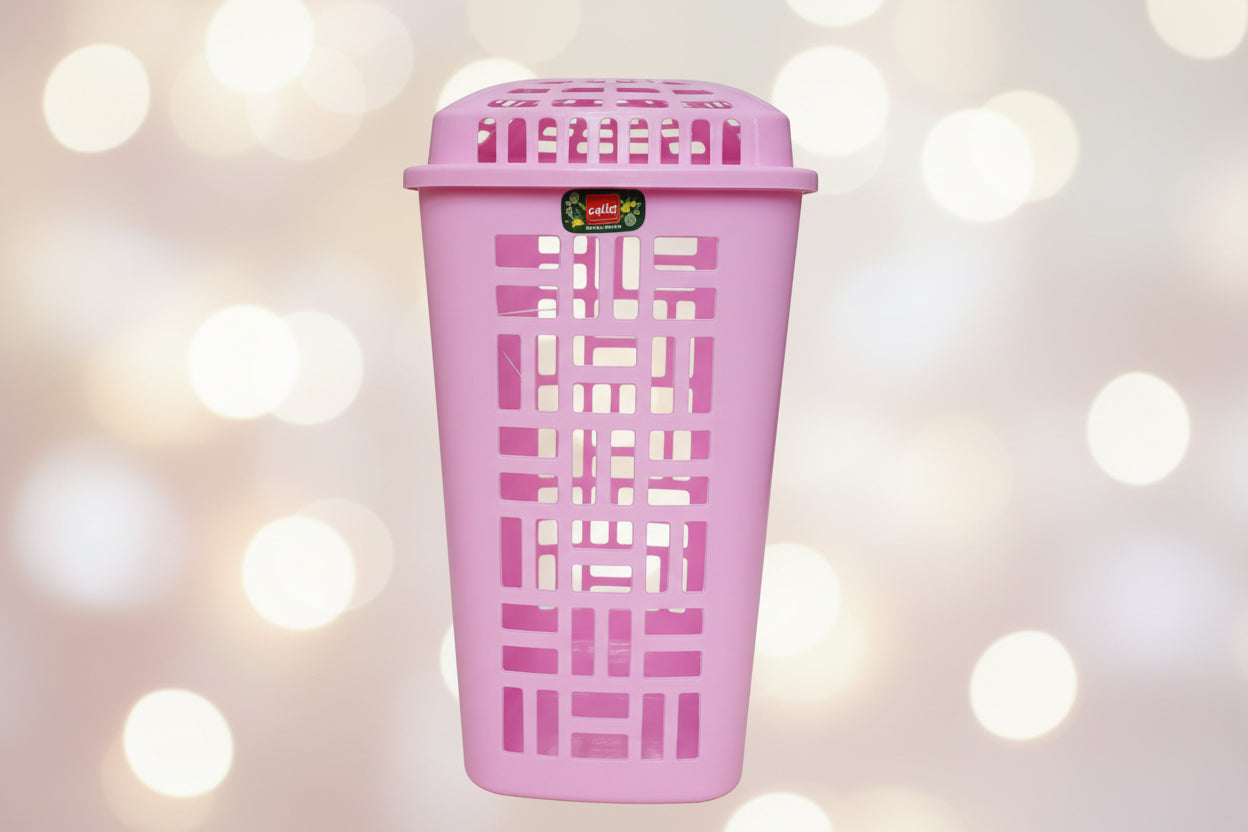 Pink plastic basket on a wooden surface with a blurred background