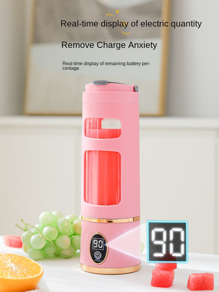 Pink electric blender with digital display on a table with fruits in the background