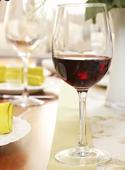 Red wine glass on a table with a blurred background