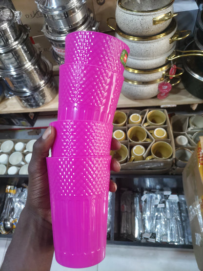 Pink cylindrical object held in front of a store shelf with various items.