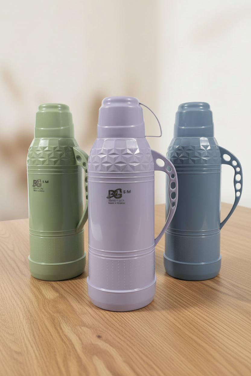 Two thermos bottles, one purple and one green, on a shelf with a blurred background.