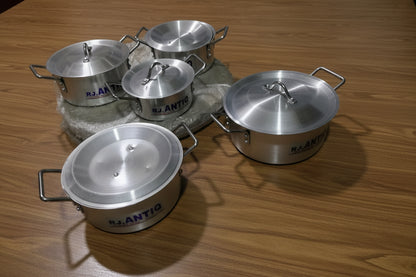 Set of silver cookware with 'R.J. Antiq' branding on a tiled floor.