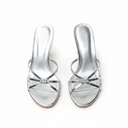 Silver strappy sandals with a neutral background