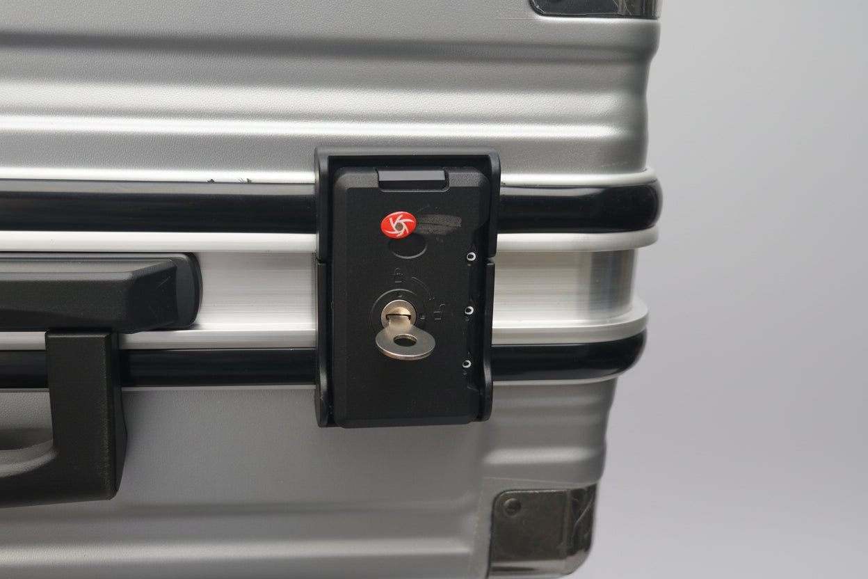 Close-up of a suitcase handle with a lock mechanism.