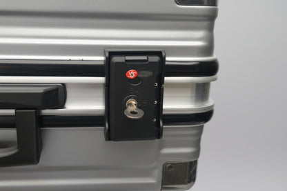 Close-up of a suitcase handle with a lock mechanism.