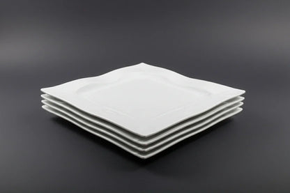 Stack of white square plates on a red stool with a blurred background