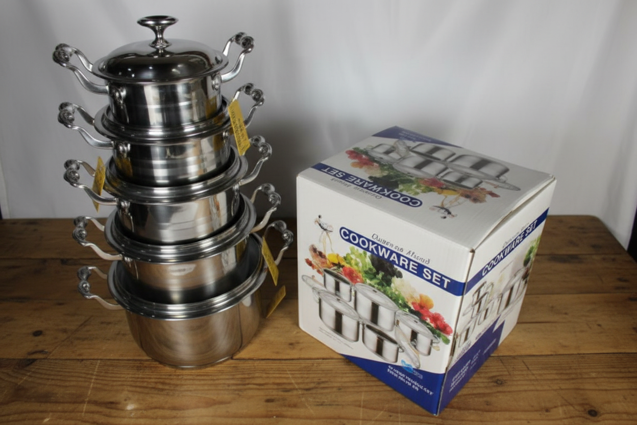 Set of stainless steel cookware with a branded box on a white background