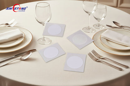 Four white square cards with circular cutouts on a white background, featuring the Xinetong logo.