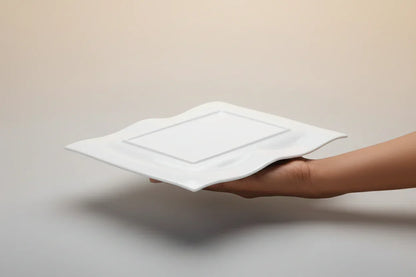 White feather held by a person in a cluttered storage room with shelves of dishes and items.