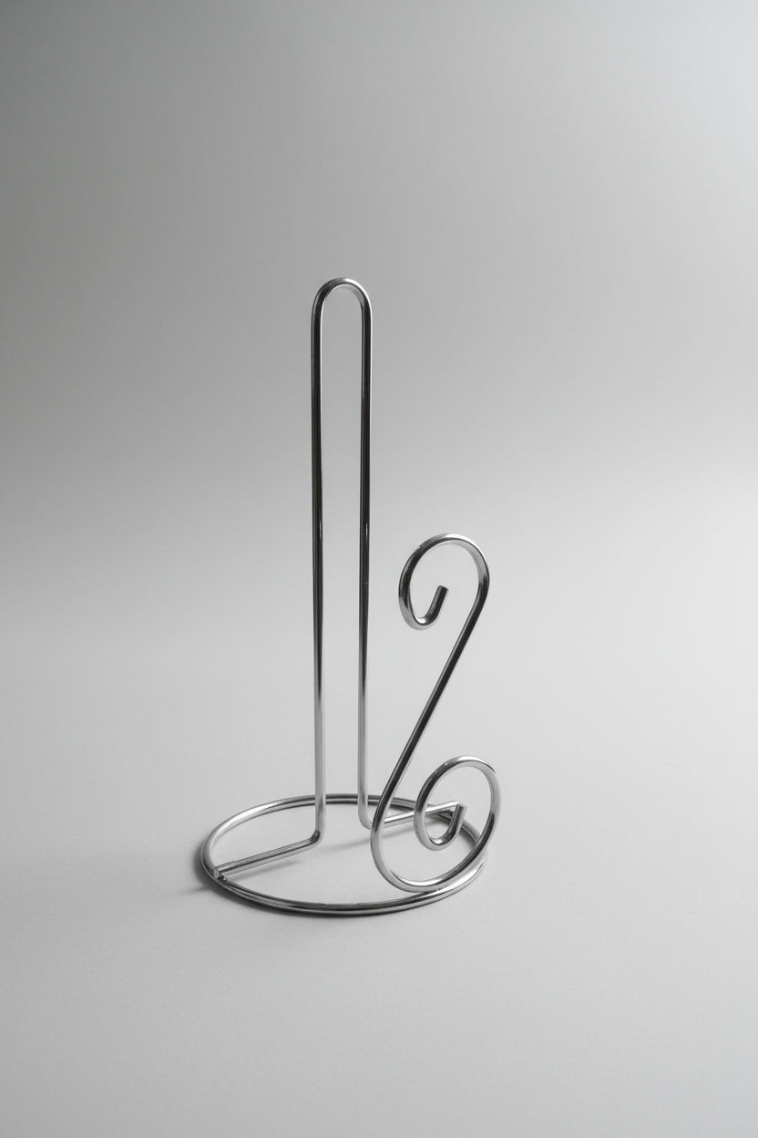 Metallic kitchen tool on a cluttered background with boxes and packaging