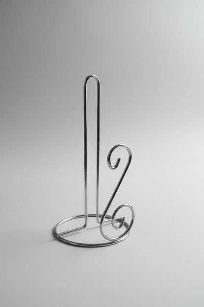 Metallic kitchen tool on a cluttered background with boxes and packaging